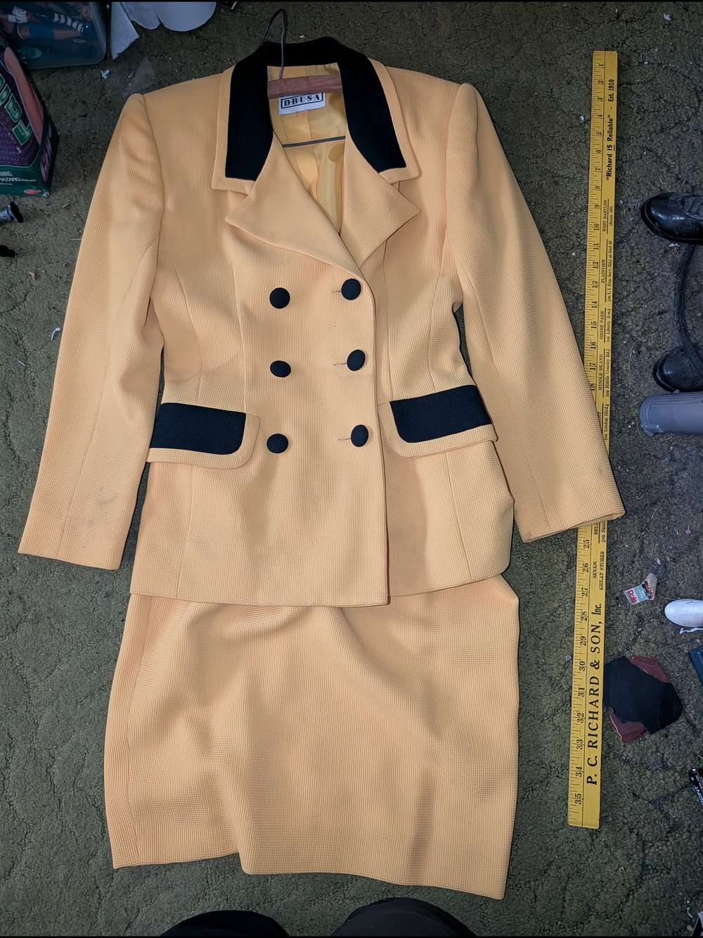 Classic Women's Two-Piece Skirt Suit in Pale Yellow with Black Trim.